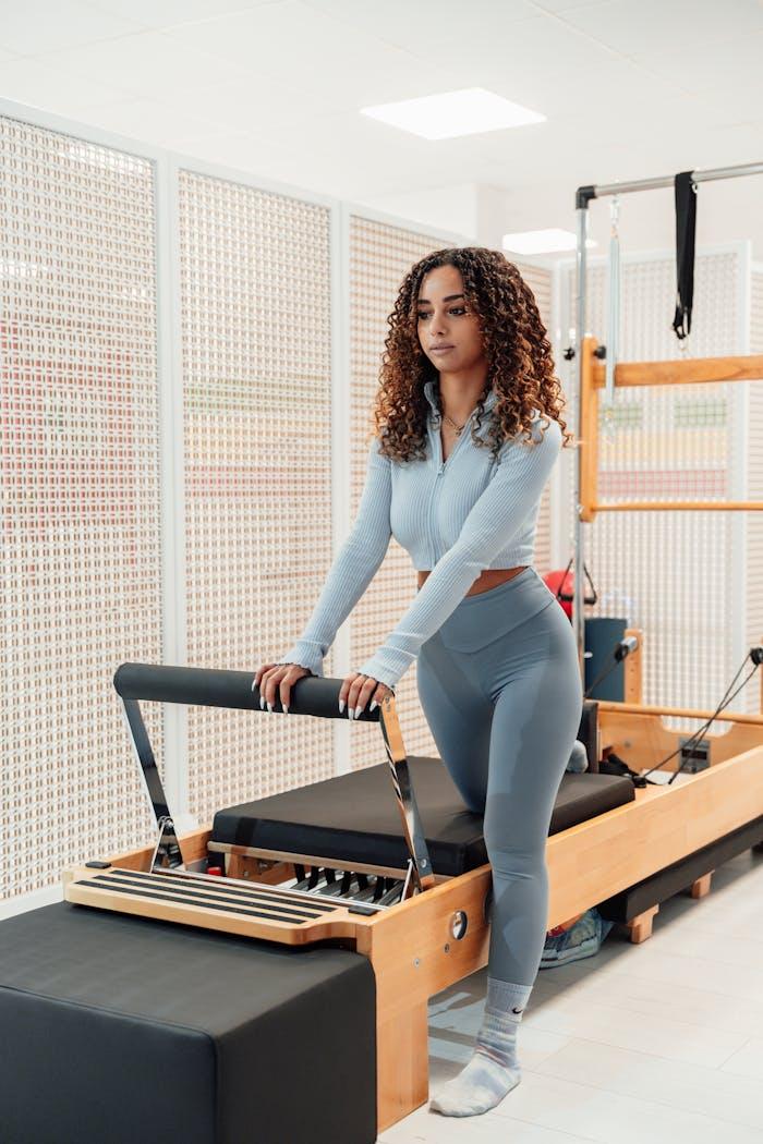 Woman by a Pilates Tower